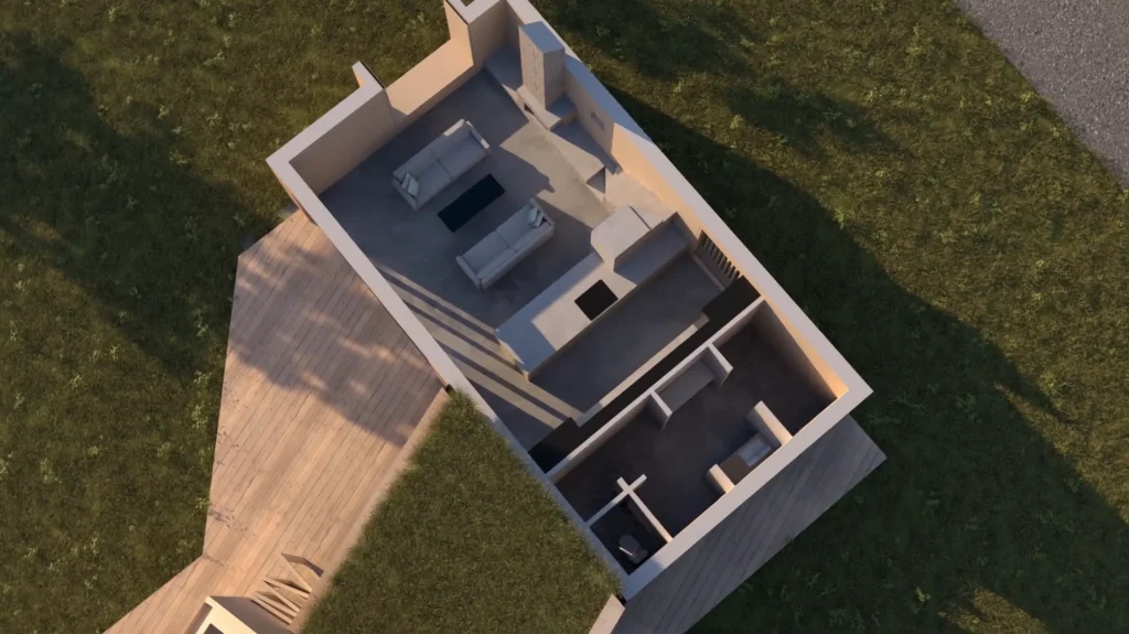 Stiligt - Flygfoto över ett litet, modernt enplanshus i Margretelund—Grand Designs-stil—med ett trädäck, två rum, ett badrum och ett vardagsrum med soffor. Huset är omgivet av gräs.