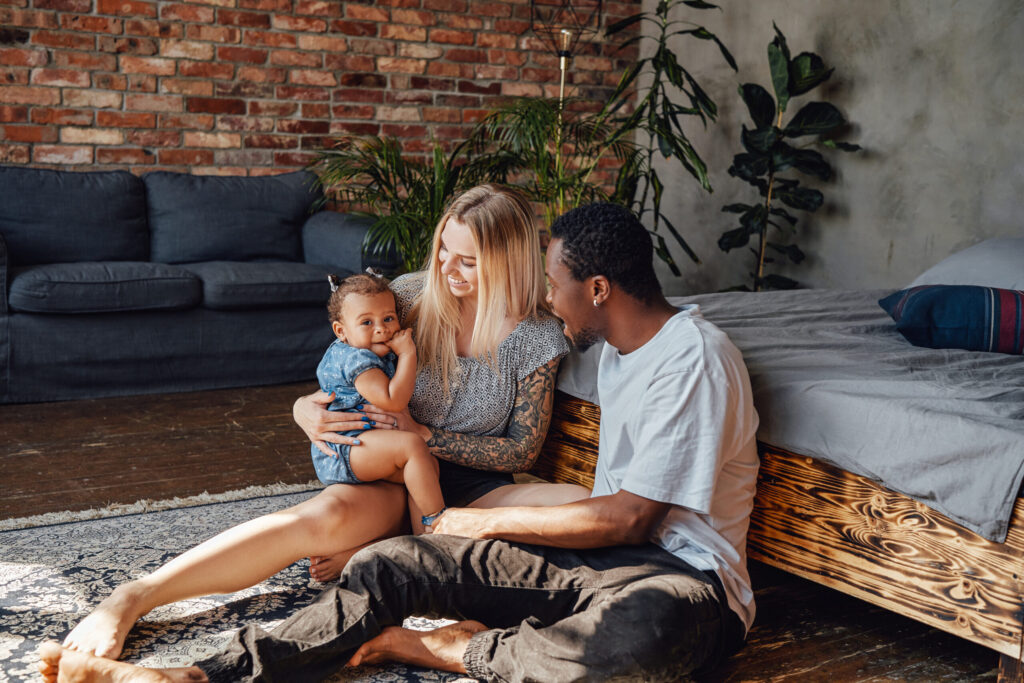 Stylish - Renovate Kitchen Guide: Great Guide with Tips and TrendsA family sits on the floor of their living room.