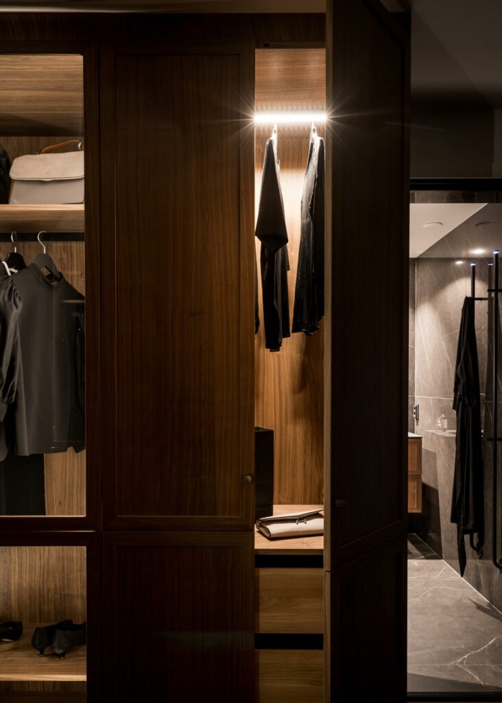 Stylish - A walk in closet with classic clothes hanging in it.
