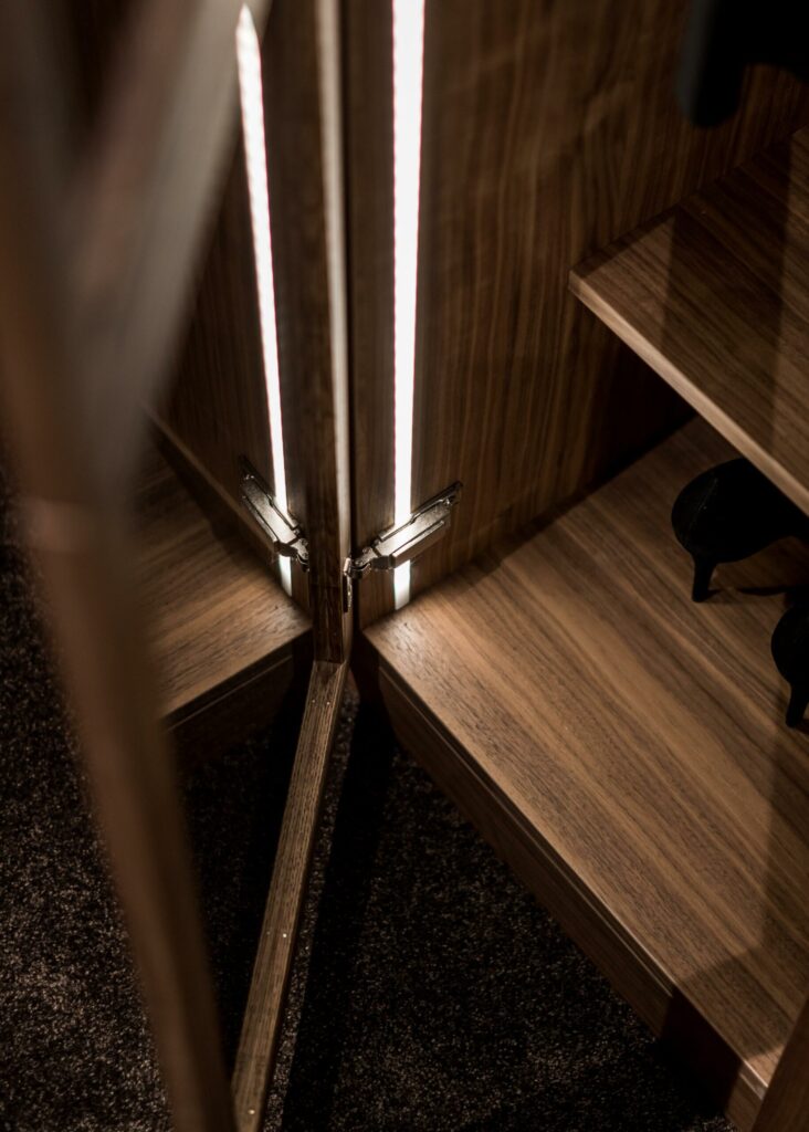 Stylish - A classic wooden wardrobe with a pair of shoes in it.
