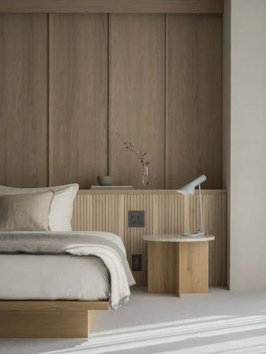 Stylish - A bedroom with white bed and wood panel designed interior design.