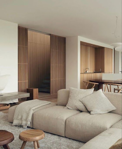 Stylish - A modern living room with beige furniture and wooden walls designed interior design.