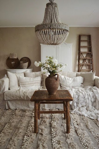 Stylish - A living room with white furniture and a chandelier interior design.