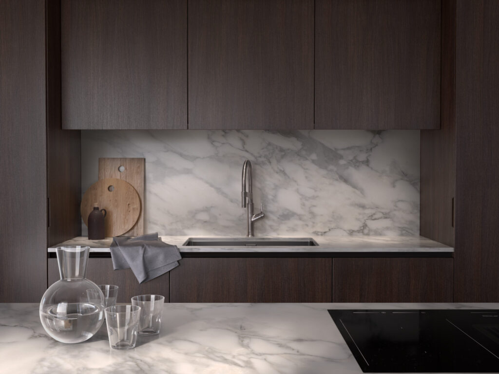 Stylish - A modern kitchen with dark wood cabinets, marble countertops and backsplash and a stylish stainless steel faucet. Complementing this is a glass carafe with glass and elegant wooden chopping boards.