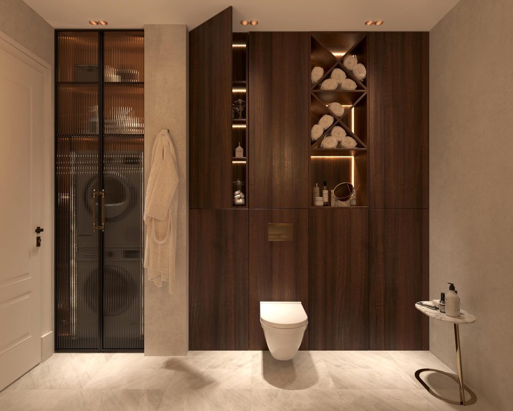Stylish - Modern bathroom with dark wood cabinetry, lighted shelves, hanging towels, a wall-mounted toilet and a marble sink. Glass door reveals a stacked washer and dryer.