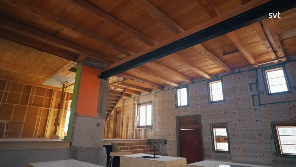 Stylish - An unfinished interior of a wooden house under construction in Lye, a true life project in Lye, with exposed beams, insulation, wiring and unpainted walls.